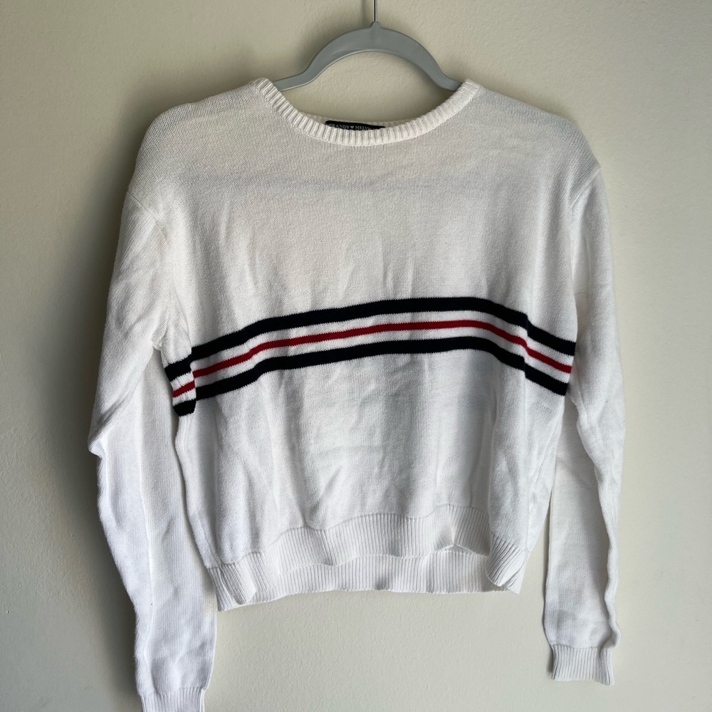 white brandy Melville sweater with blue and red strip